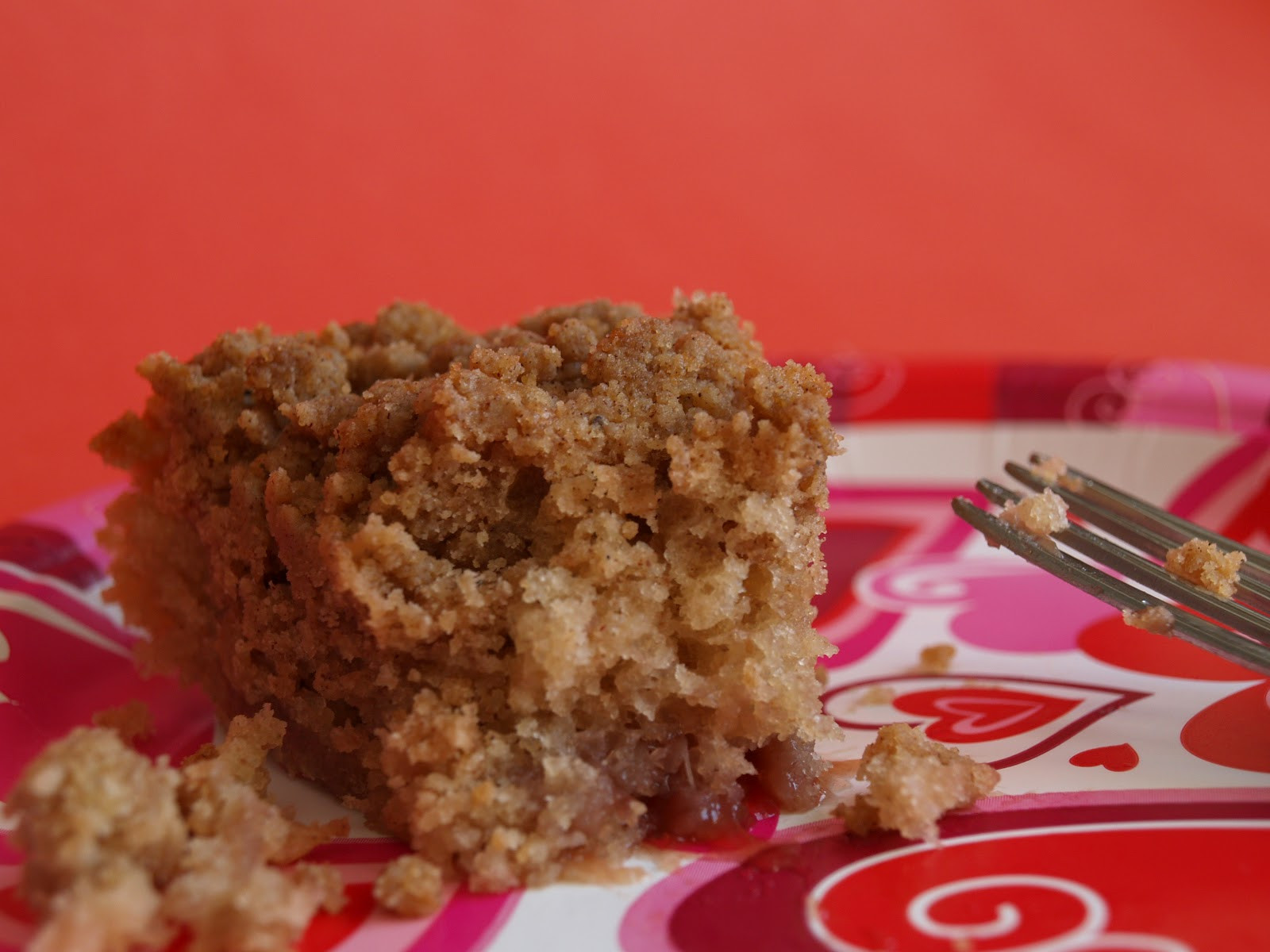 A piece of eaten cake showing jam inside