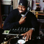 Frankie Knuckles spinning records in his Chicago home, a pioneer of house music.