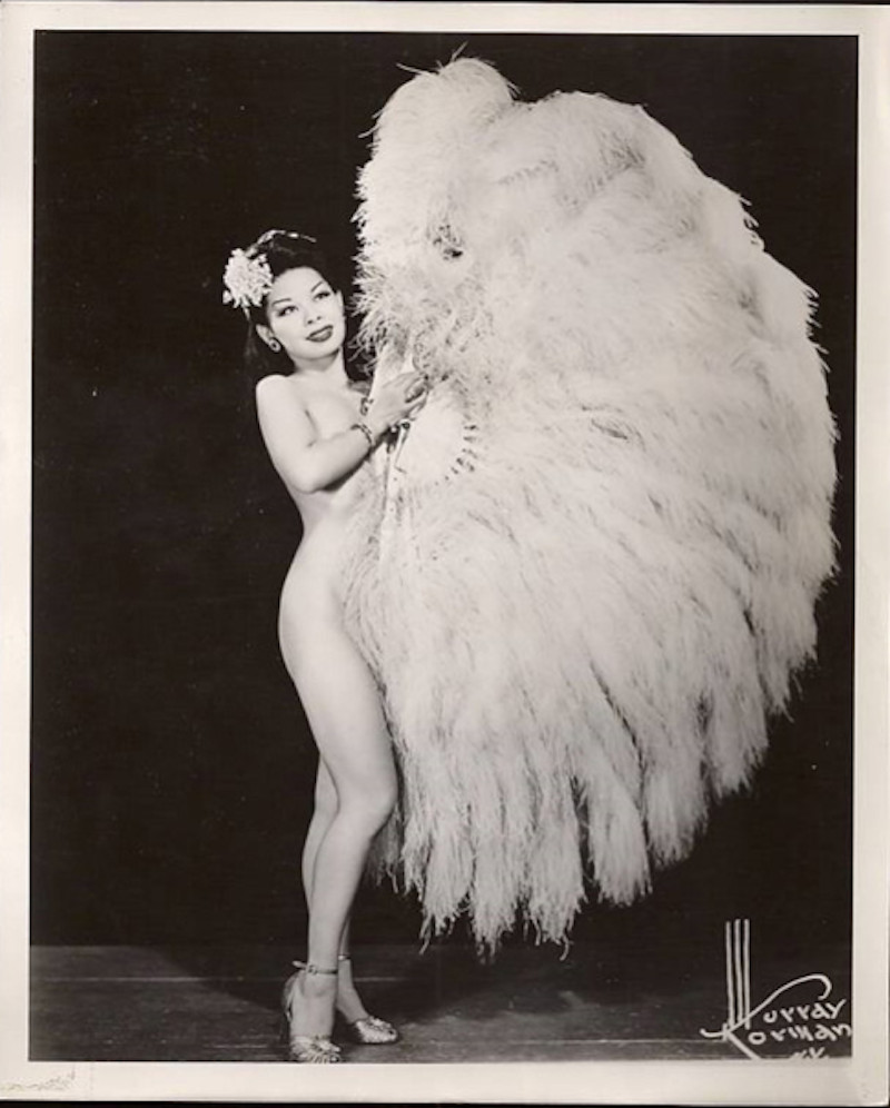 A photograph of Noel Toy taken by Murray Norman, capturing her allure and poise, and contributing to her image as a burlesque dancer who brought a unique Asian American flair to the art form during the Forbidden City era.