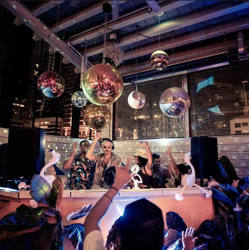 People dancing under laser lights at Coconut Club Austin
