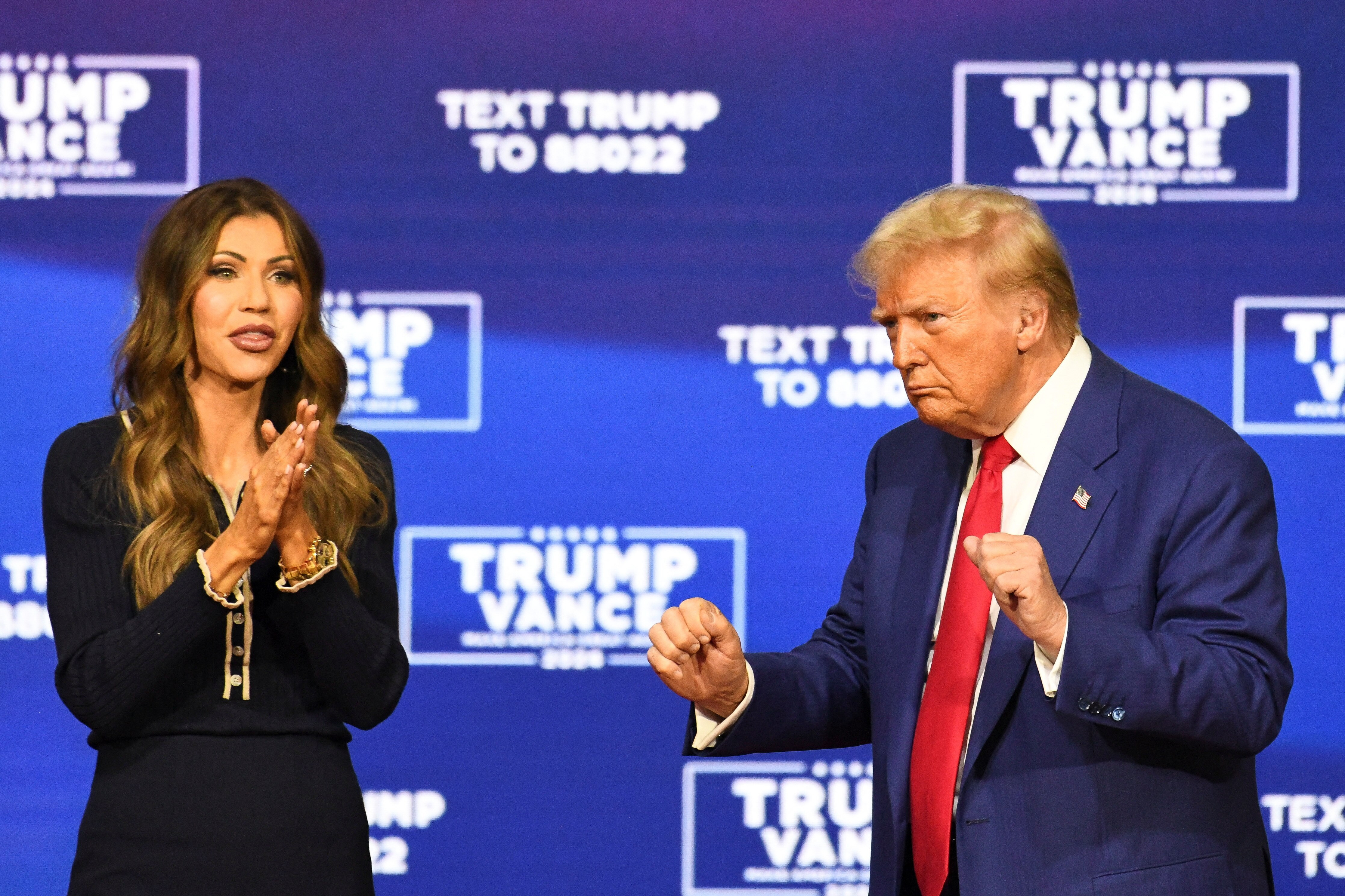 Kristi Noem and Donald Trump dance at election event