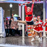 Dancers performing at Light Up Downtown event in festive costumes