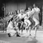Scene from 42nd Street showcasing the bustling energy of the backstage world, highlighting the film's depiction of a vibrant 'dance street' environment within the theater.