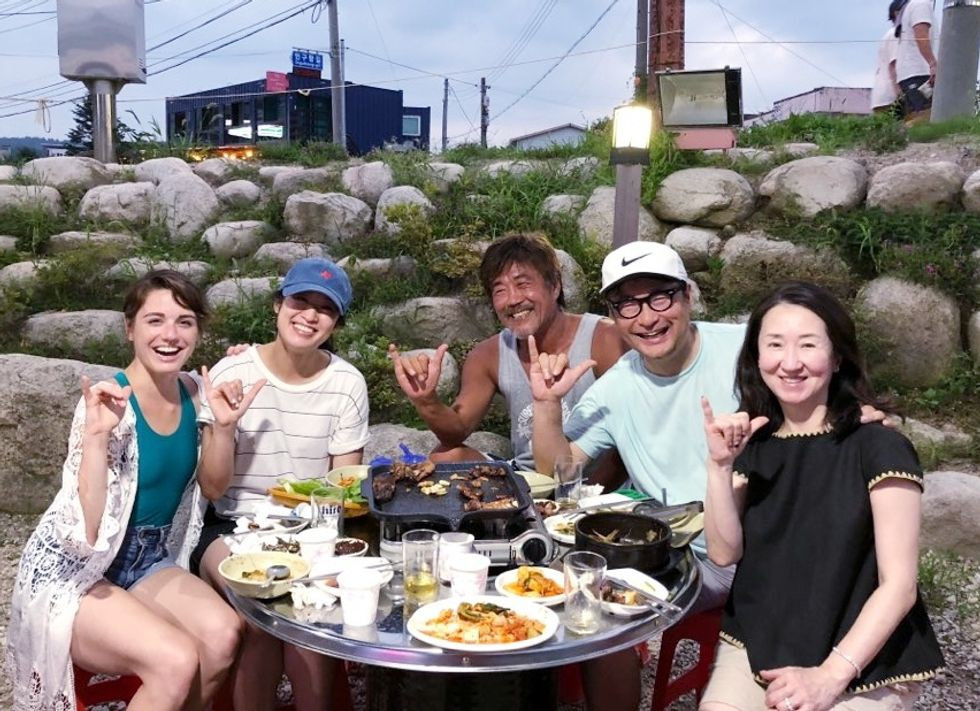 Dancer sharing a meal with Japanese friends, experiencing local culture