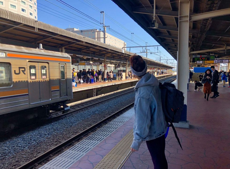 Dancer waiting for the JR Keiyo Line train, experiencing Tokyo public transport