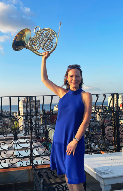 Sarah Willis performing with the Havana Lyceum Orchestra in a concert hall, highlighting the collaboration on &quot;Cuban Dances&quot; project.