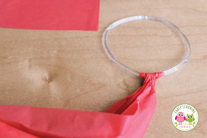 Further steps illustrating the process of tightening the knot to securely attach the ribbon to the ring for the homemade dance ribbon.