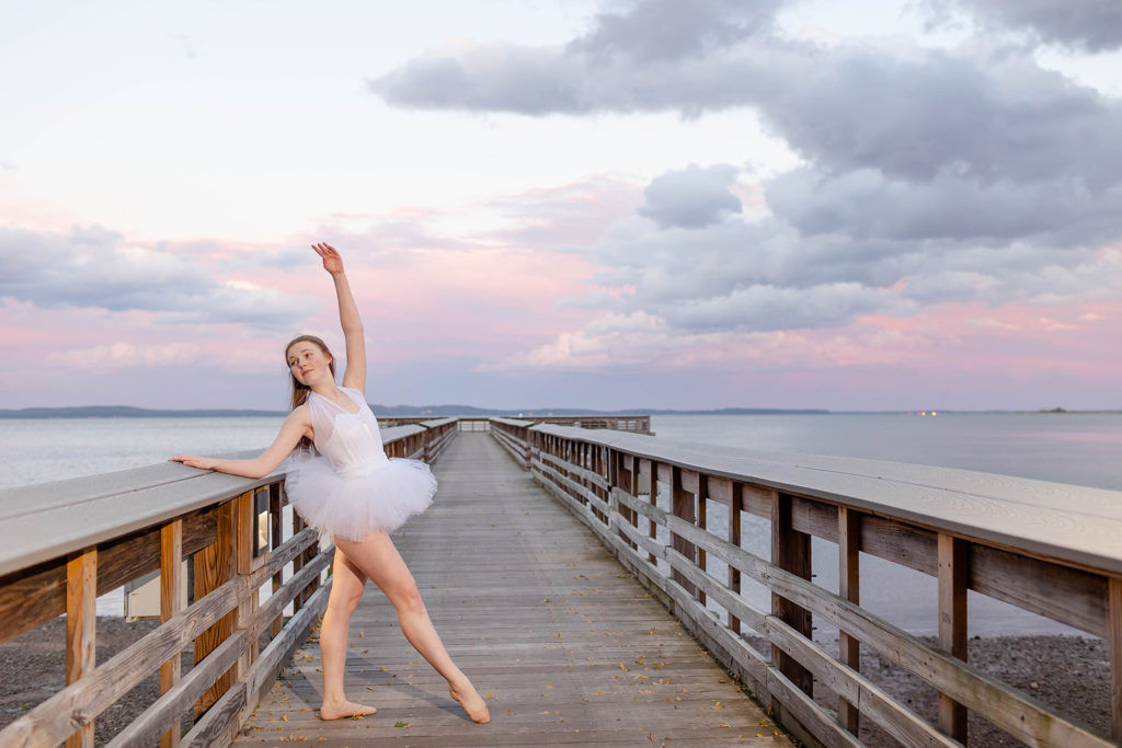 Energetic jazz dancer mid-jump, highlighting the athleticism of dance photography.