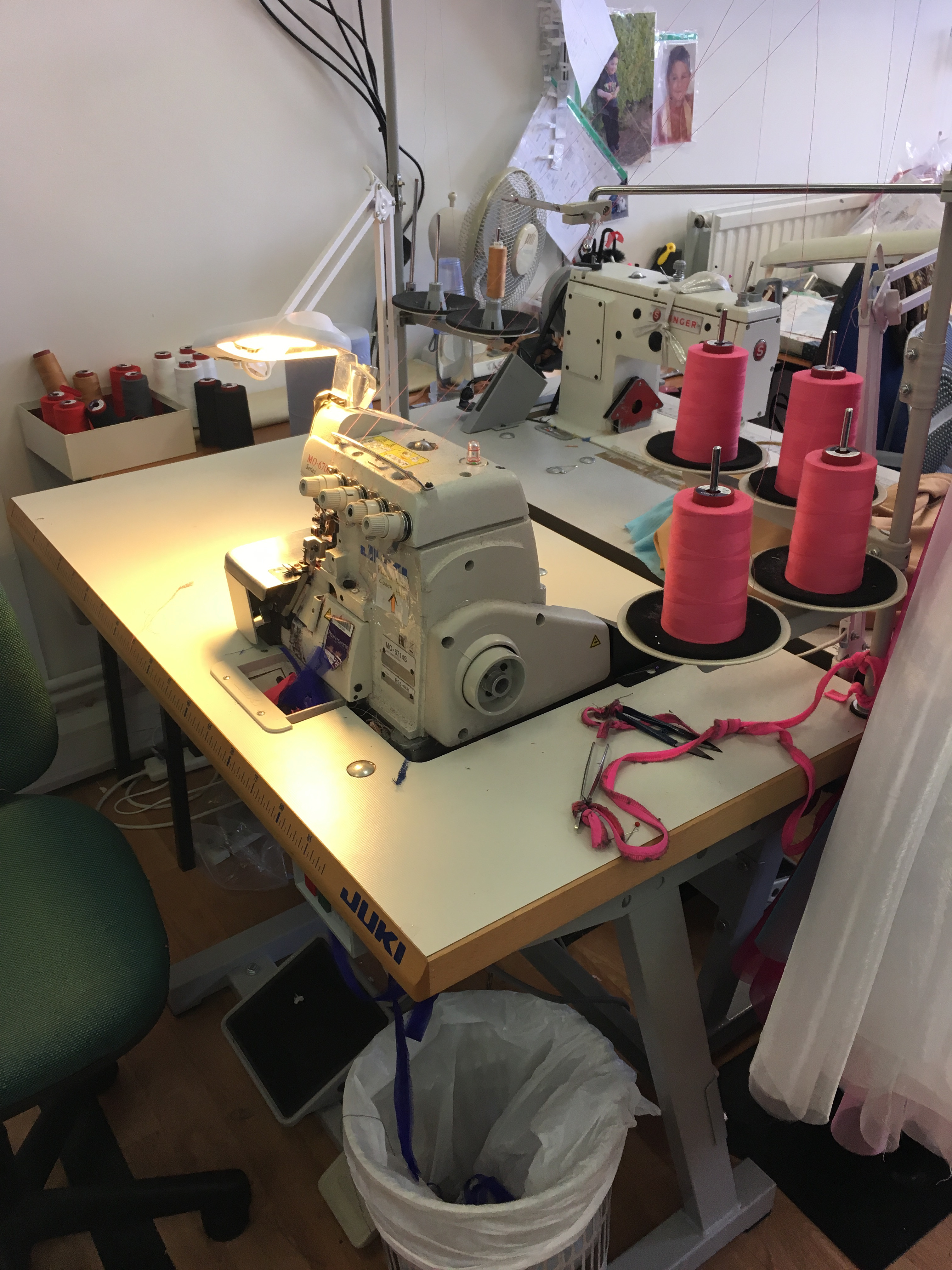 A rack of completed or near-completed dance costumes, showcasing the vibrant colors and dynamic designs ready for the dance floor.