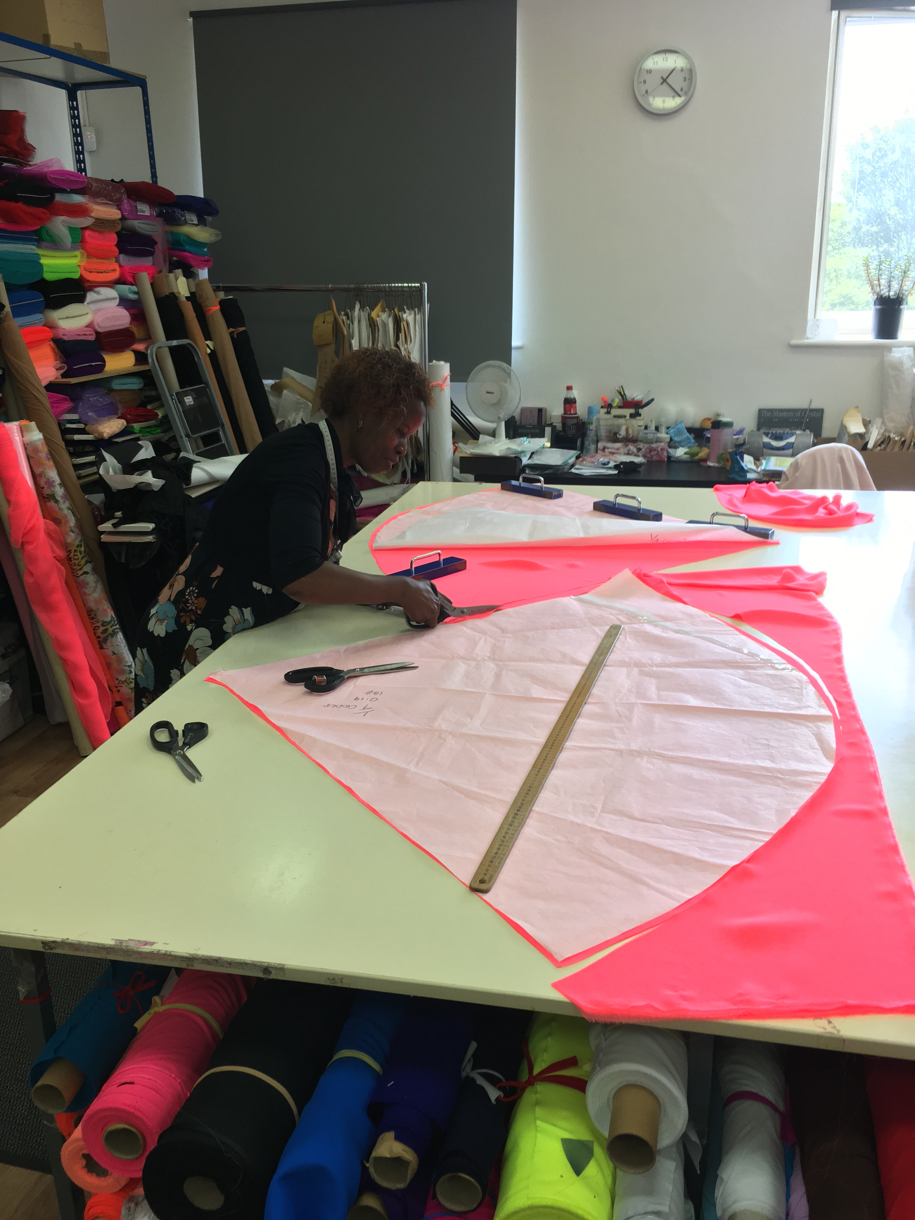 Garments in progress on mannequins, illustrating the various stages of construction and the use of mannequins for fitting and design assessment.