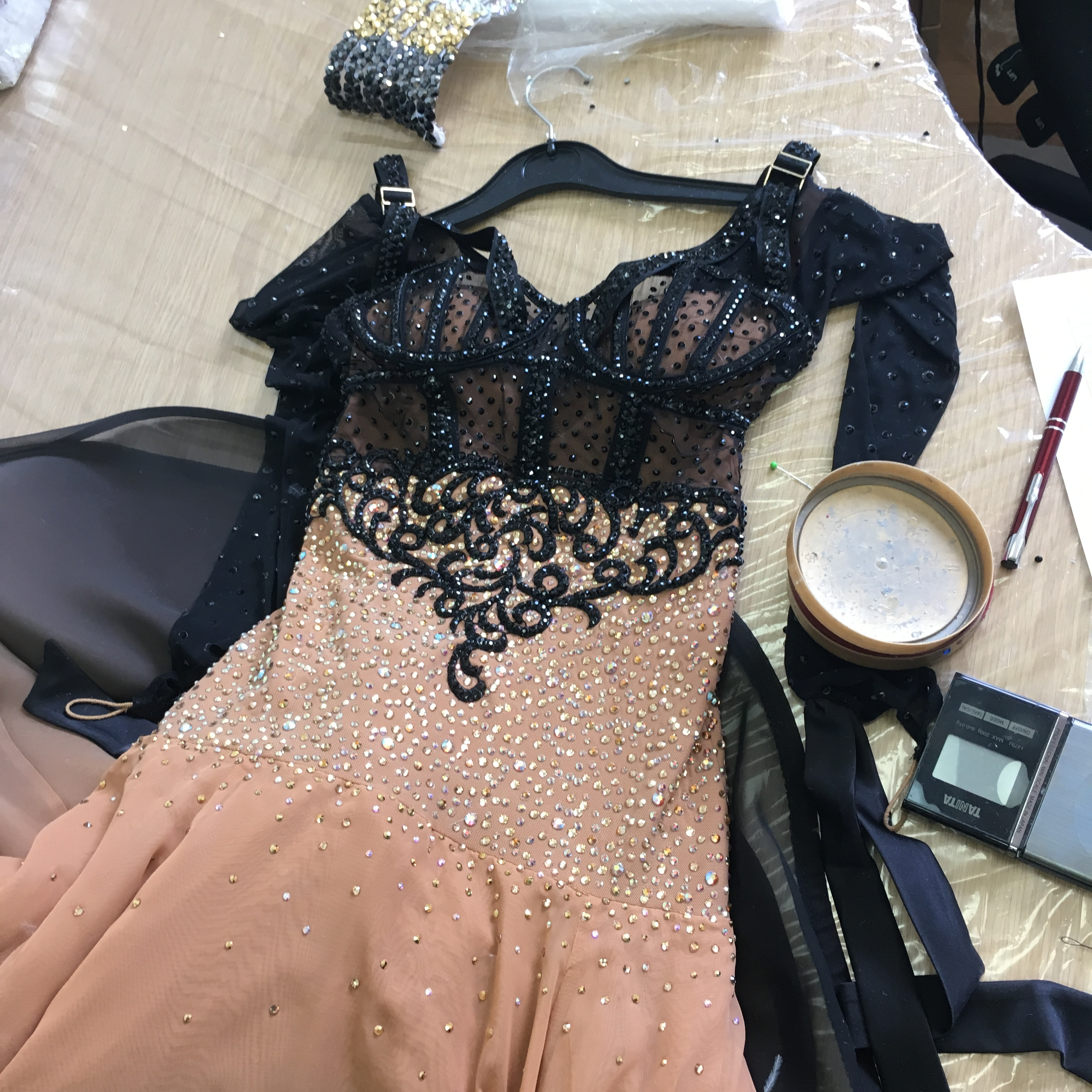 Detailed view of hand-applied stones on a dance costume bodice, emphasizing the artistry and precision of embellishing dancewear.