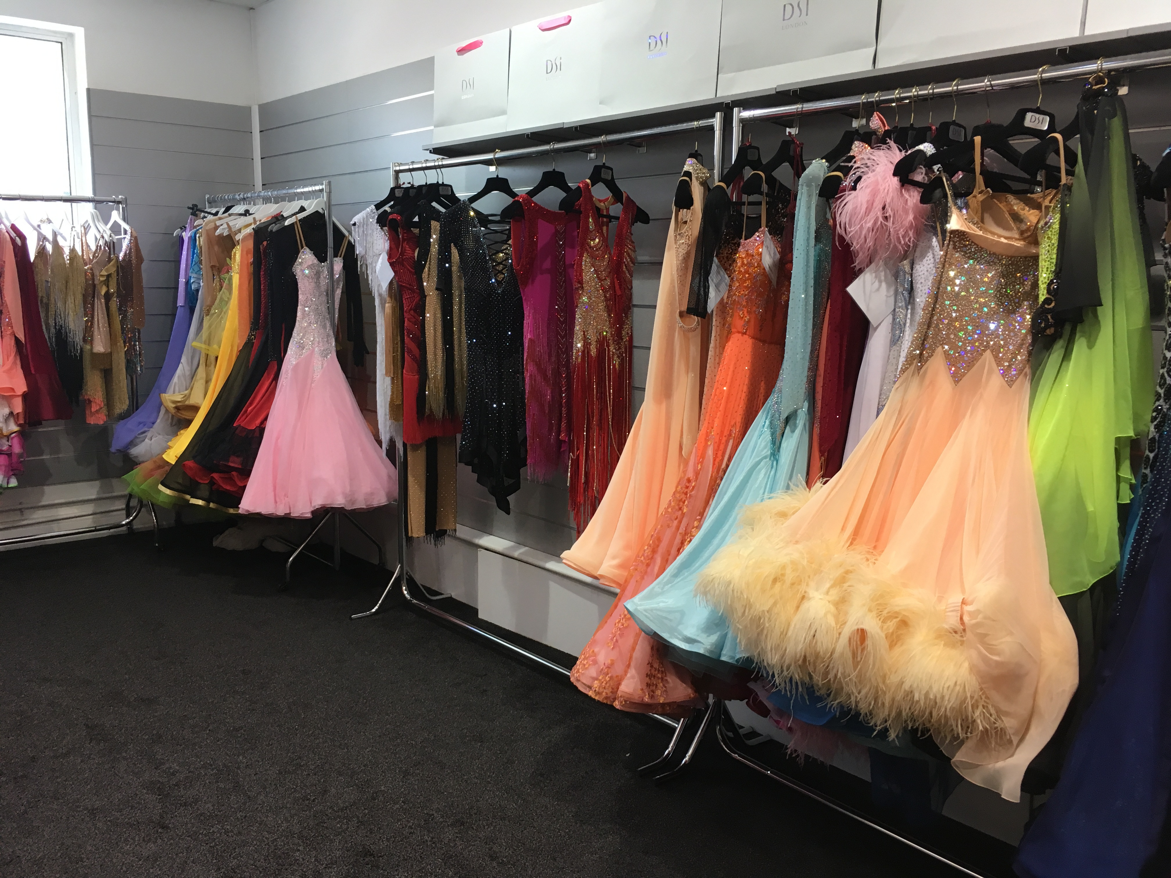 A range of dance costume styles available, showcasing different silhouettes and designs in ballroom and Latin dance attire.