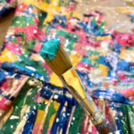 Close-up of acrylic paint layers on a dance costume, showcasing texture and depth.
