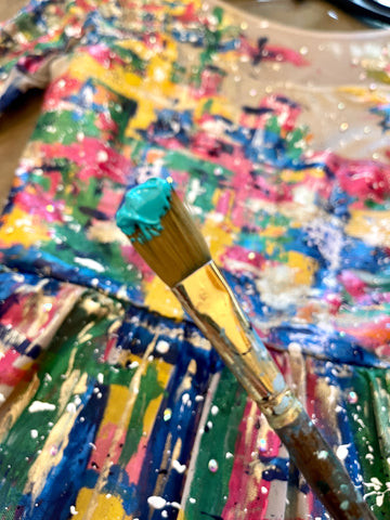 Close-up of acrylic paint layers on a dance costume, showcasing texture and depth.