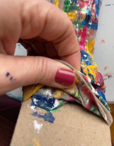 Close view of painted mesh on a dance costume, illustrating the challenge of painting on flexible fabric.