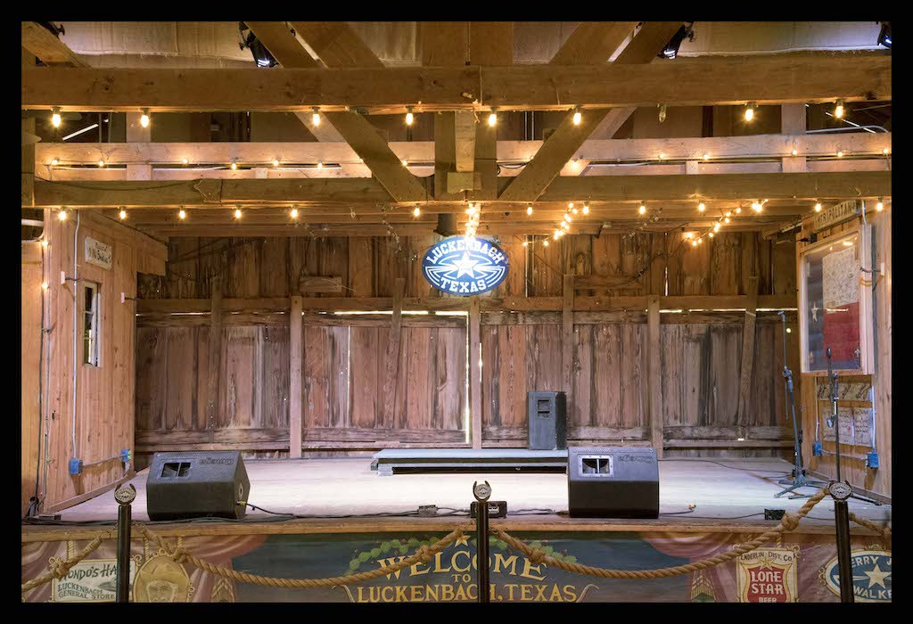 The stage inside Luckenbach Dance Hall, highlighting the intimate and historic setting for live music performances.