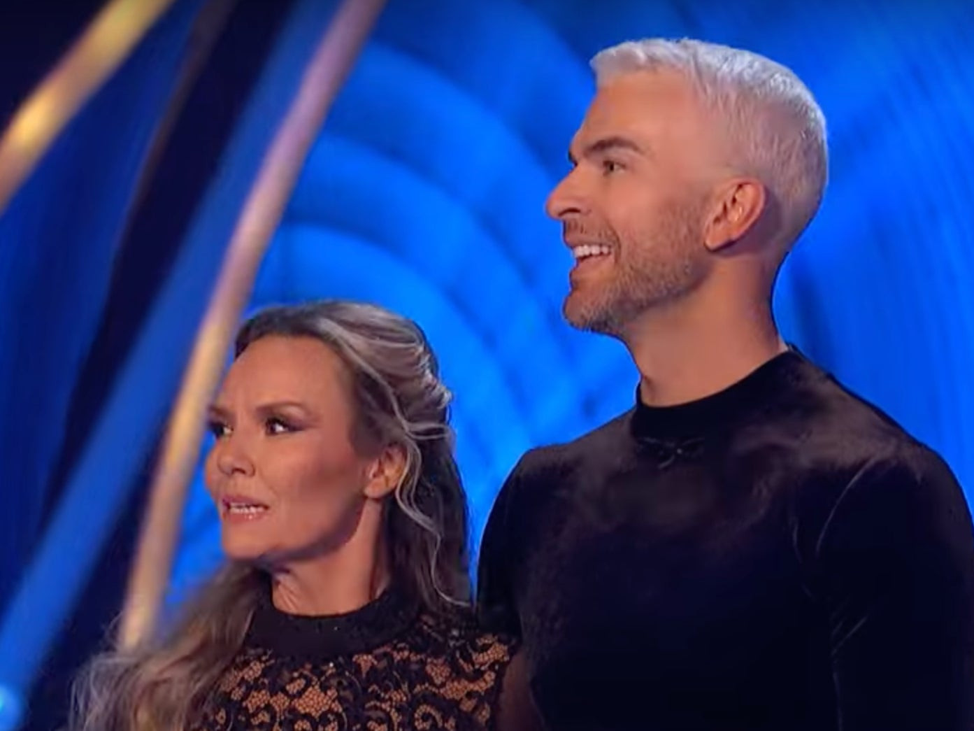 Dancing on Ice partners Charlie Brooks and Ed Radford smiling on the ice rink before Radford's injury forced a cast change.
