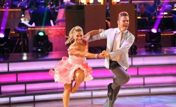 Shawn Johnson performing on Dancing with the Stars, showcasing her athletic grace and beaming smile.