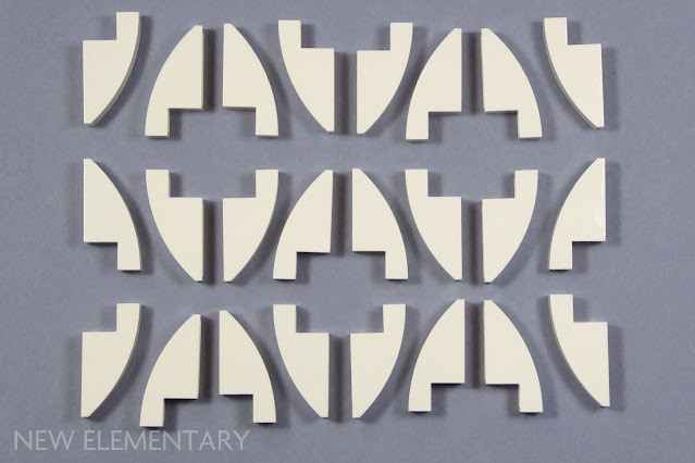 A collection of white curved LEGO slope bricks, part of the Dancing Groot set, showcasing the quantity of these versatile pieces.