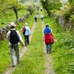 Pilgrims dancing in Glendalough, Ireland, embodying the spirit of 'we dance' during a Holy Disorder of Dancing Monks pilgrimage