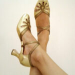 Beige dance shoes designed for swing dancing to elongate legs
