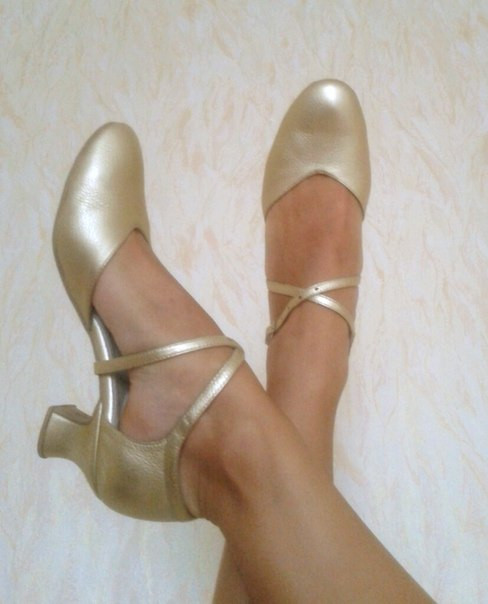 Golden dance shoes for Charleston performance, blending with skin tone