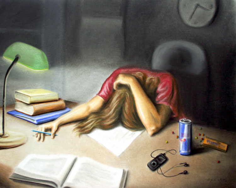A student deeply engrossed in studying textbooks and notes.