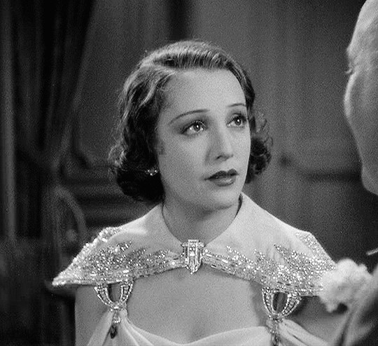 GIF of Bebe Daniels and George Brent in 42nd Street, emphasizing the romantic chemistry between their characters and the film's exploration of relationships amidst the theatrical setting.