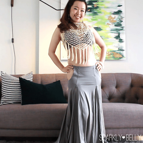 Hip scarf tied at the back of the neck and draped over the chest