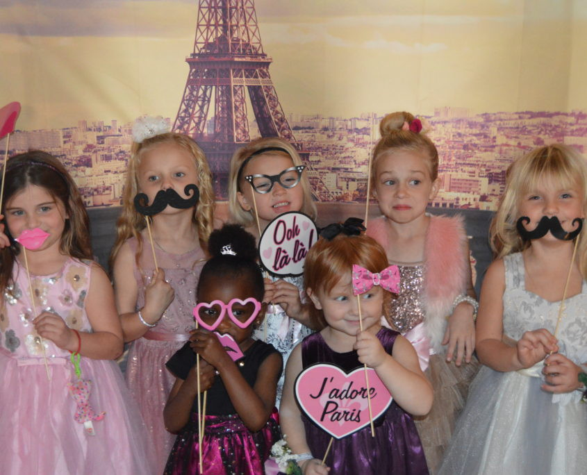Girls enjoying a &quot;Night in Paris&quot; dance, showing elegance and smiles in a ballroom