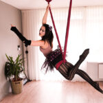 Aerial silk dancers gracefully intertwining, showcasing the fluid and dynamic movements characteristic of this art form.