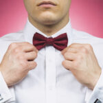 A young man in a stylish suit and bow tie