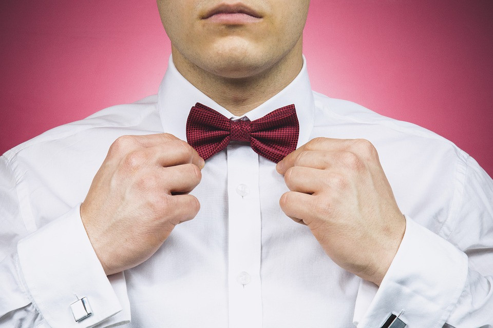 A young man in a stylish suit and bow tie