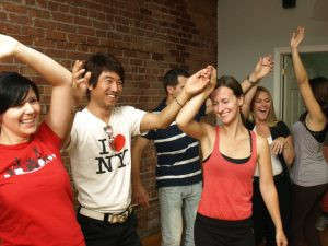 Swing dance class in progress with students rotating