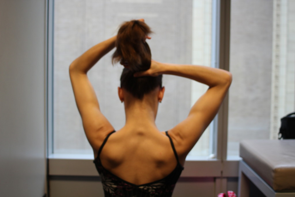 Holding hair in a ponytail position before twisting