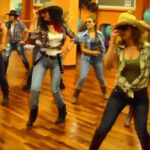 People line dancing in a bar
