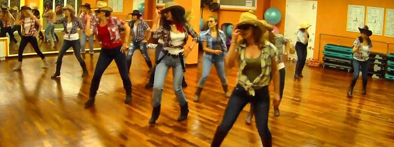 People line dancing in a bar