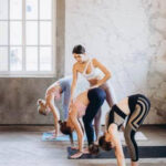 Fitness instructor working with students, leading a dance fitness class