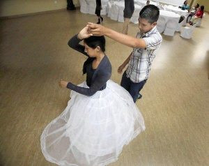 Young girl practices dance in a long skirt